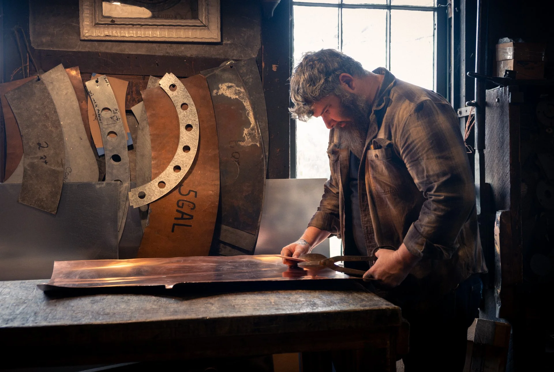 BCKW Museum - website image - James cutting copper sheet-2.jpg