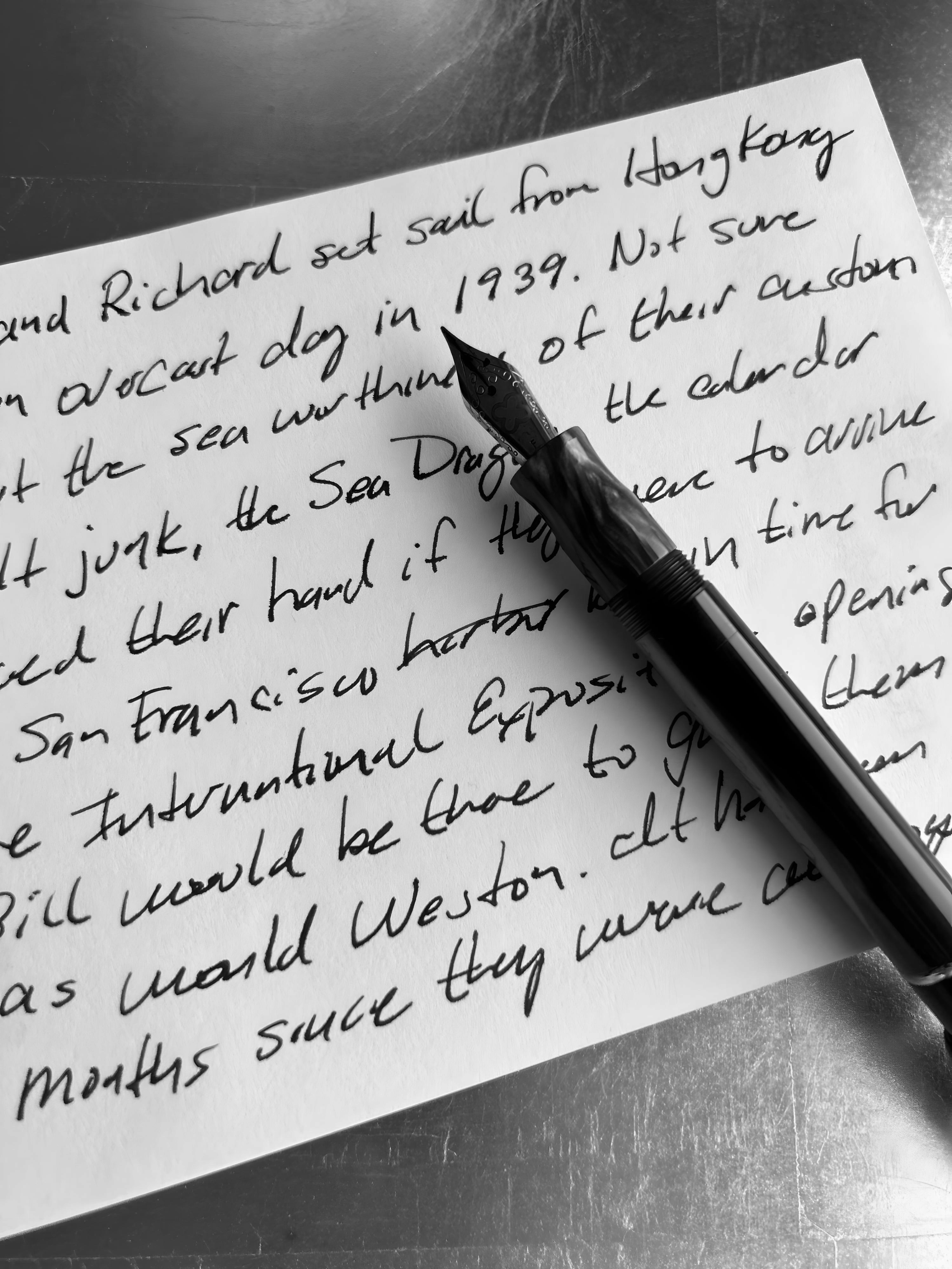 Handwritten note with fountain pen on metal surface.
