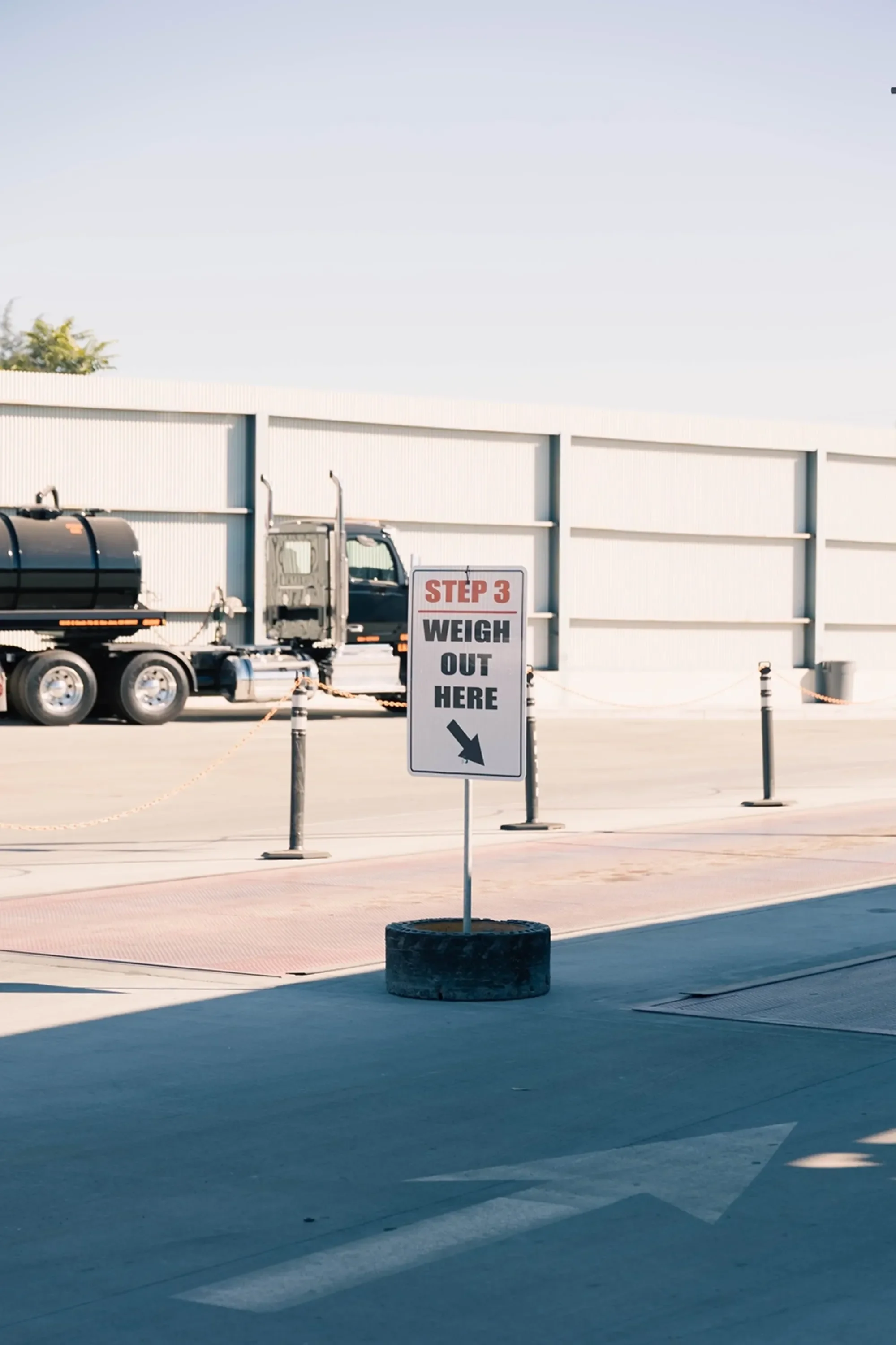 Truck weighing station with sign "Step 3 Weigh Out Here"