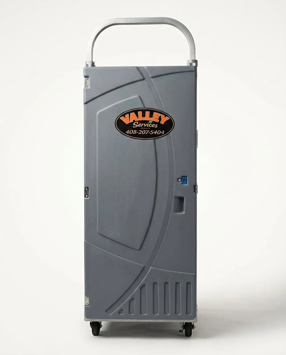 A gray portable cleaning machine or equipment case with a handle on top and wheels at the bottom, featuring a Valley Services logo and phone number on the front.