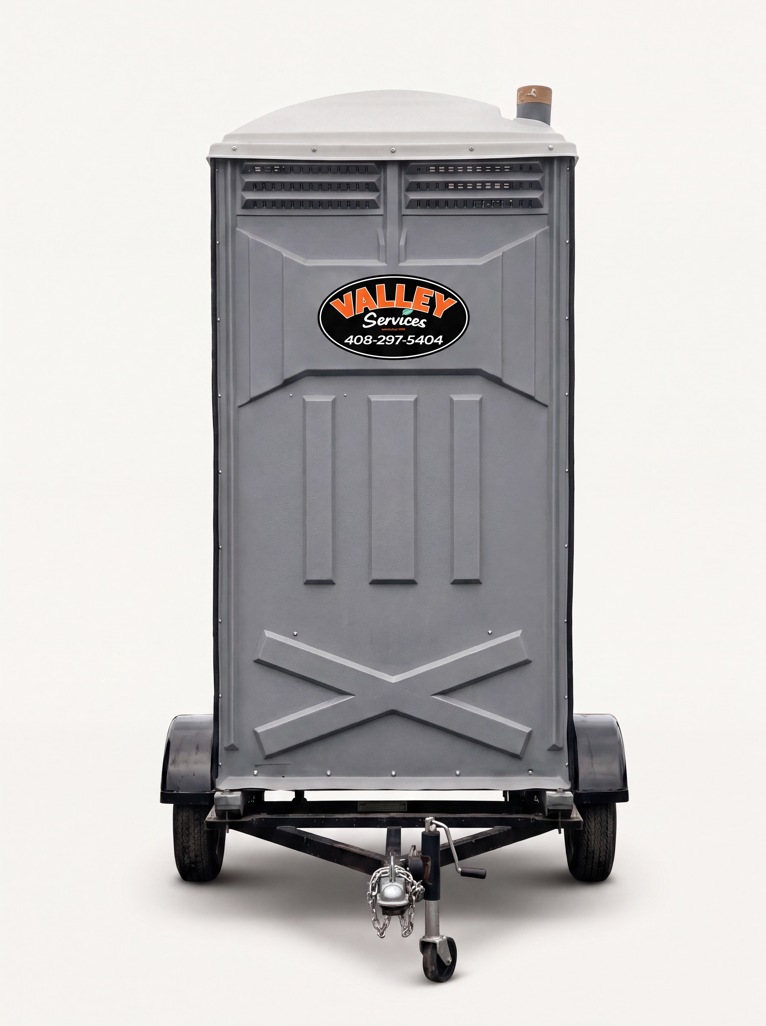 Portable toilets with "Valley Services" branding and a trailer in a sunny outdoor setting.