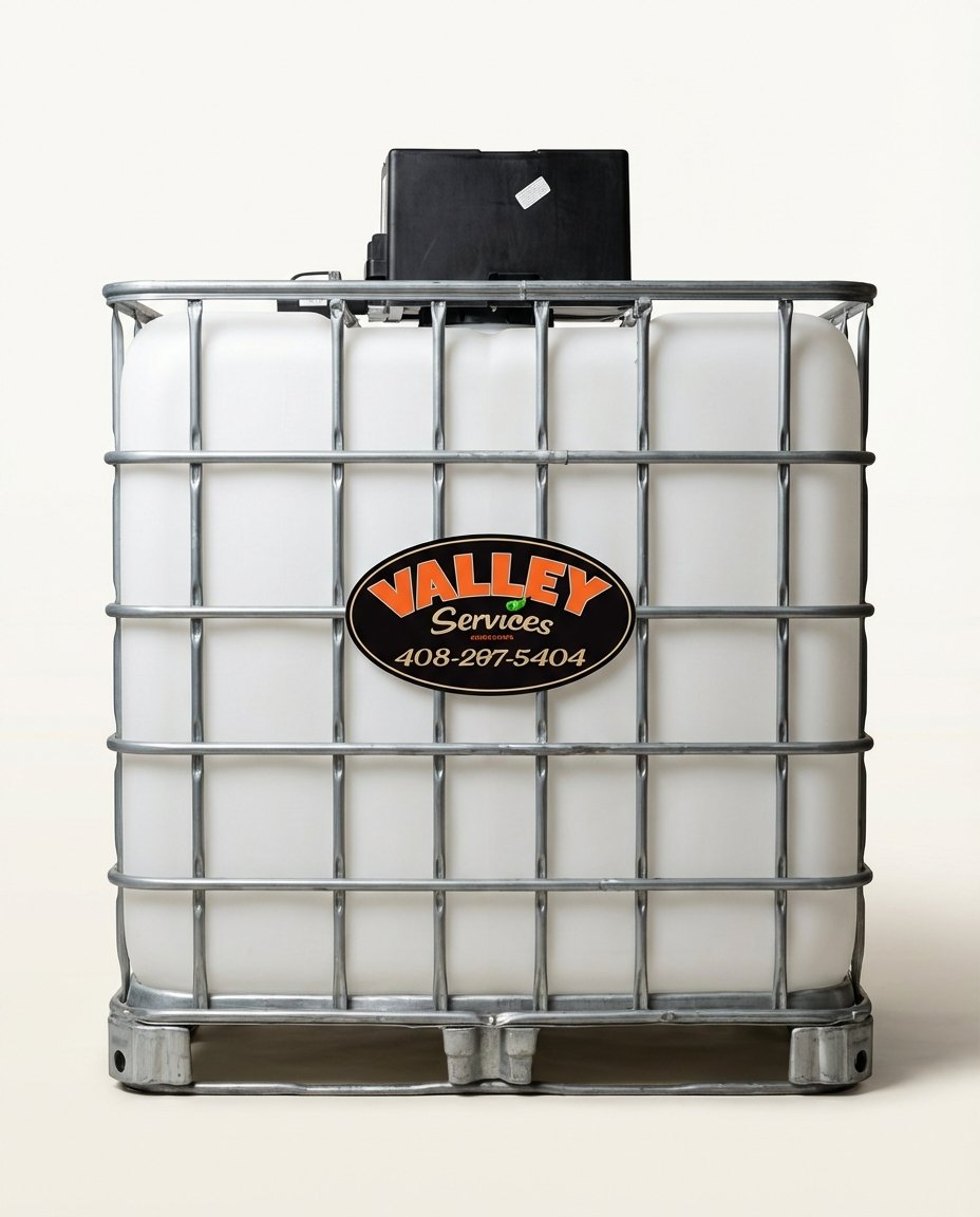 Large white plastic container with metal cage, labeled 'Valley Services' with a phone number, and a black box on top, isolated on a plain background.