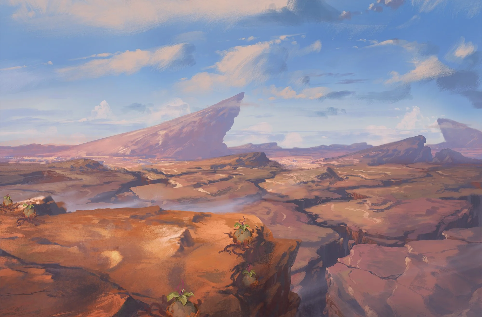 A rocky mountain range on a bright day. The land is covered in low rocky hills and ravines, in the distance are tall peaks.