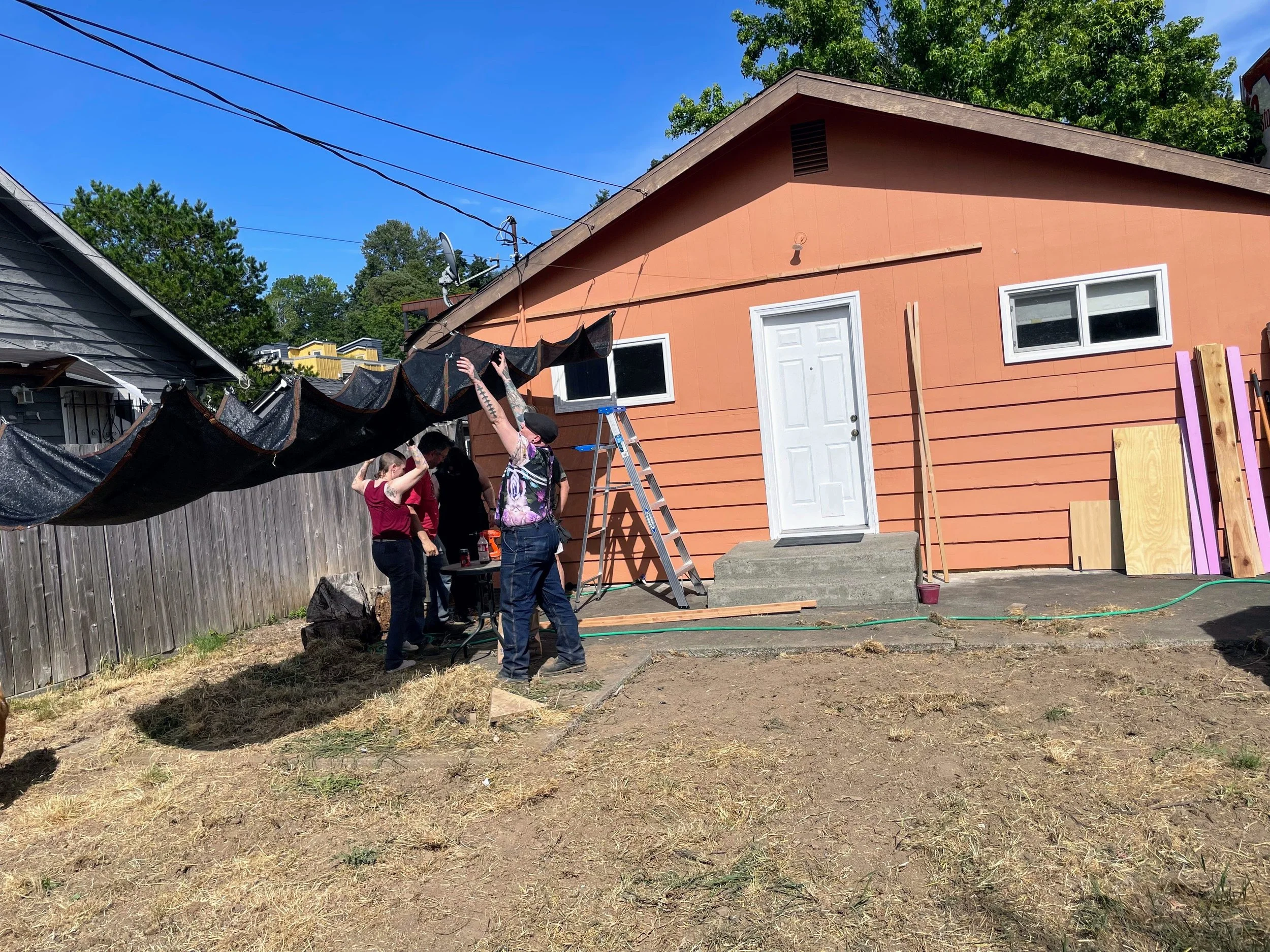 Volunteers setting up a shaded area