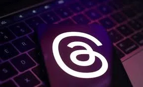 App icon with a white stylized 'a' on a purple background, placed on a laptop keyboard.
