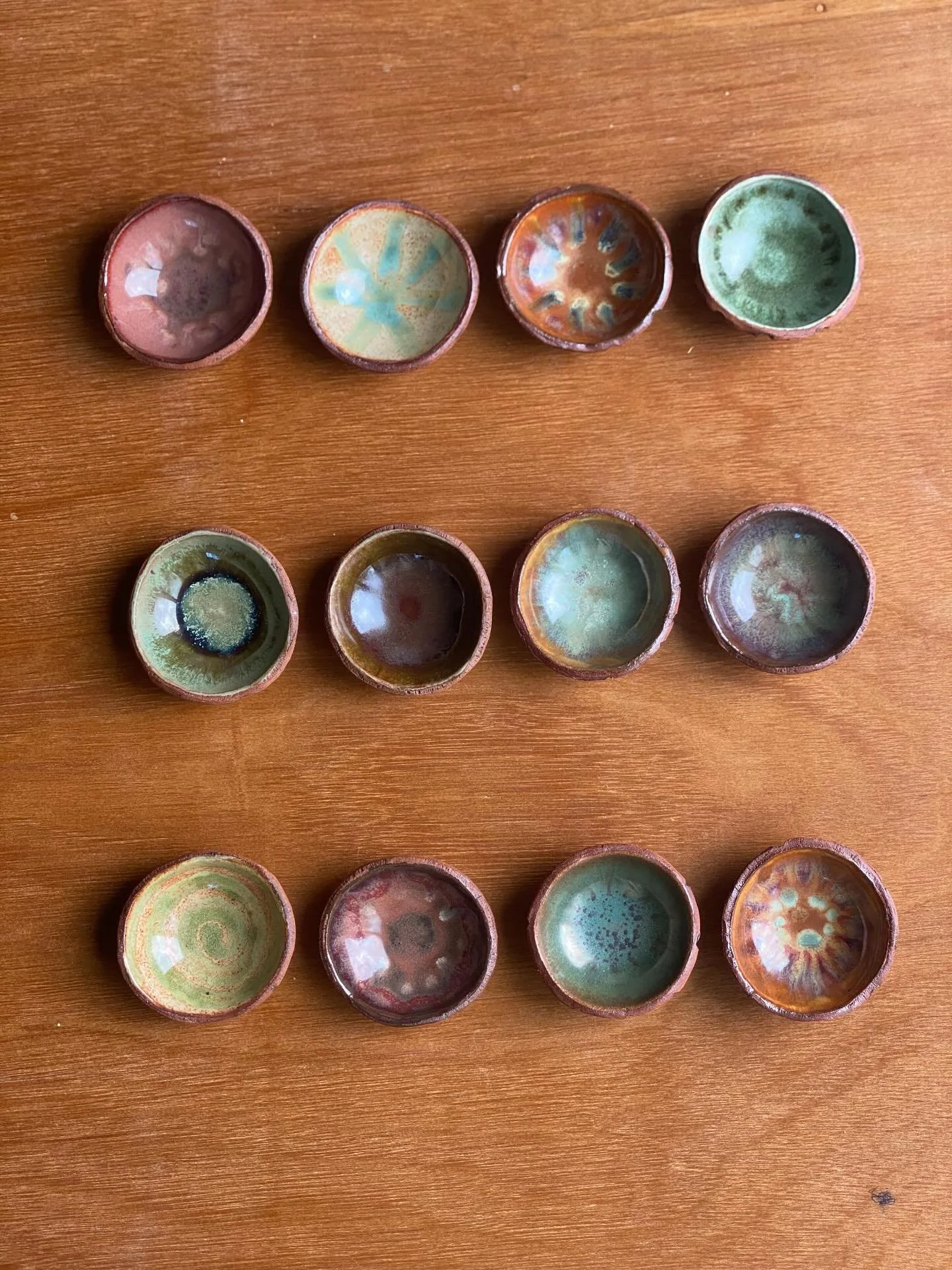 3 sets of 4 dipping bowls. (sauce bowls?) 
All 12 were glazed with varying combinations of thr same 5 glazes for a mismatched but cohesive vibe.

I love how the glazes came out, and the earthy colorway