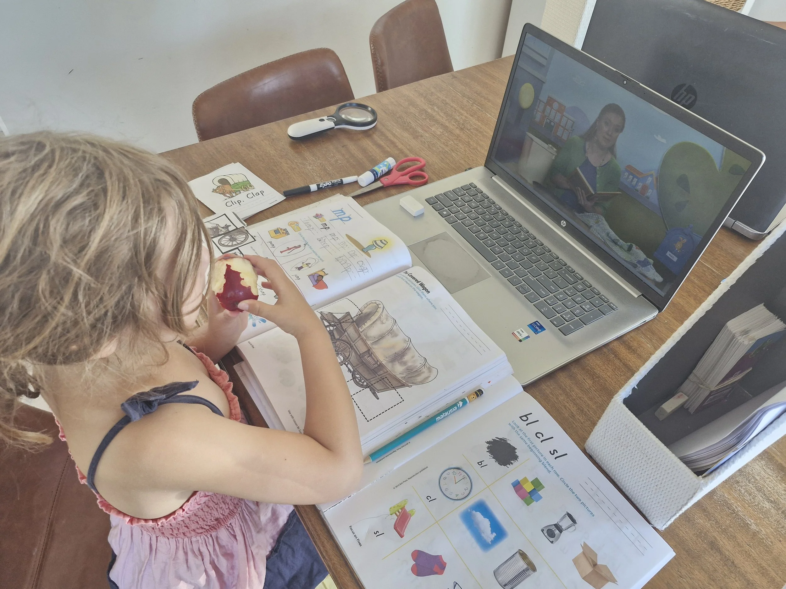 Penny doing workbook and video lessons for her Kindergarten.
