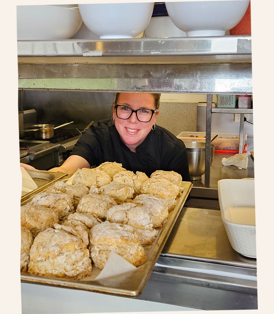 Hannah Setchell peeking through from the kitchen with fresh scones
