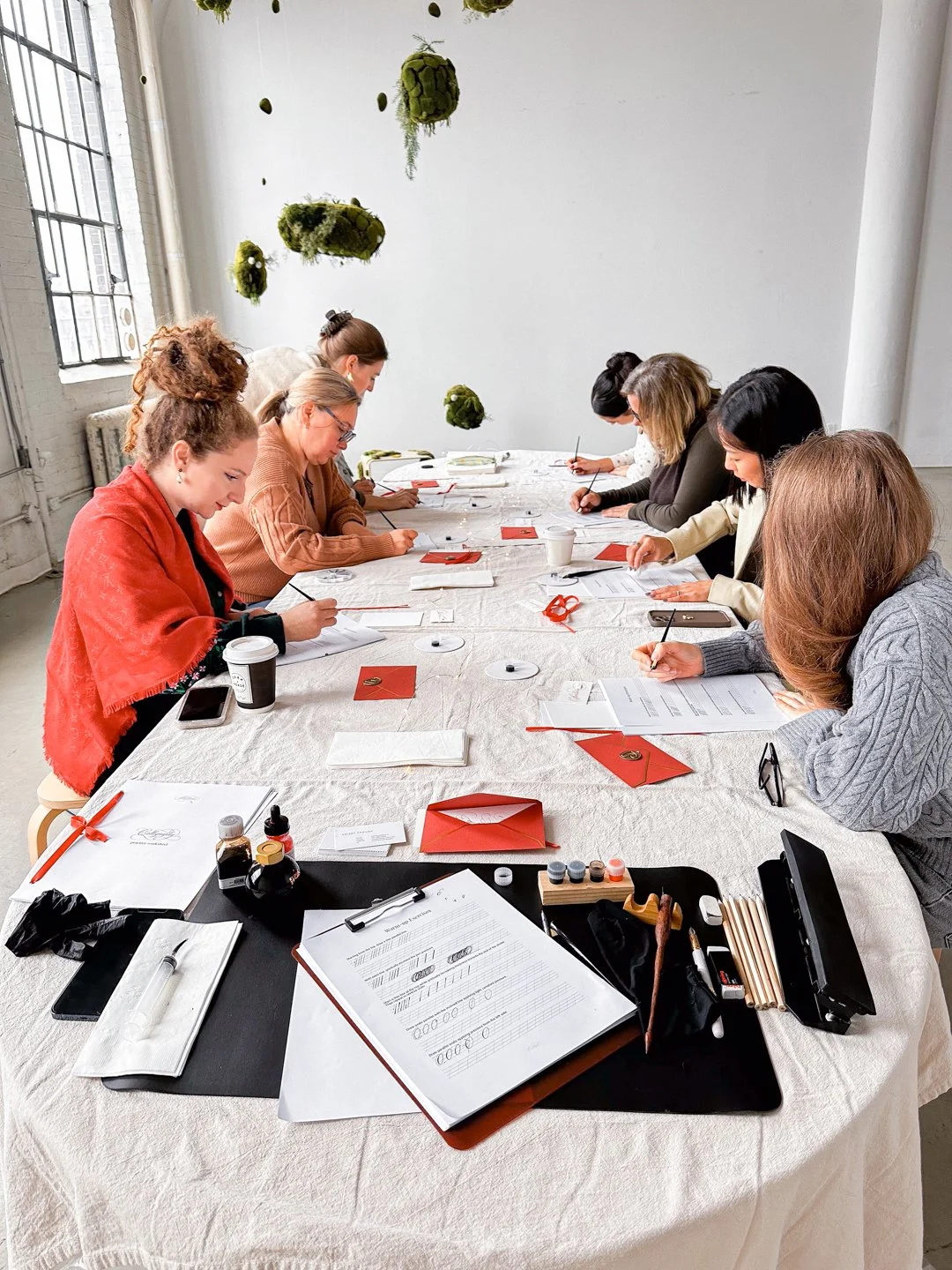 Participants practicing modern calligraphy during a corporate workshop