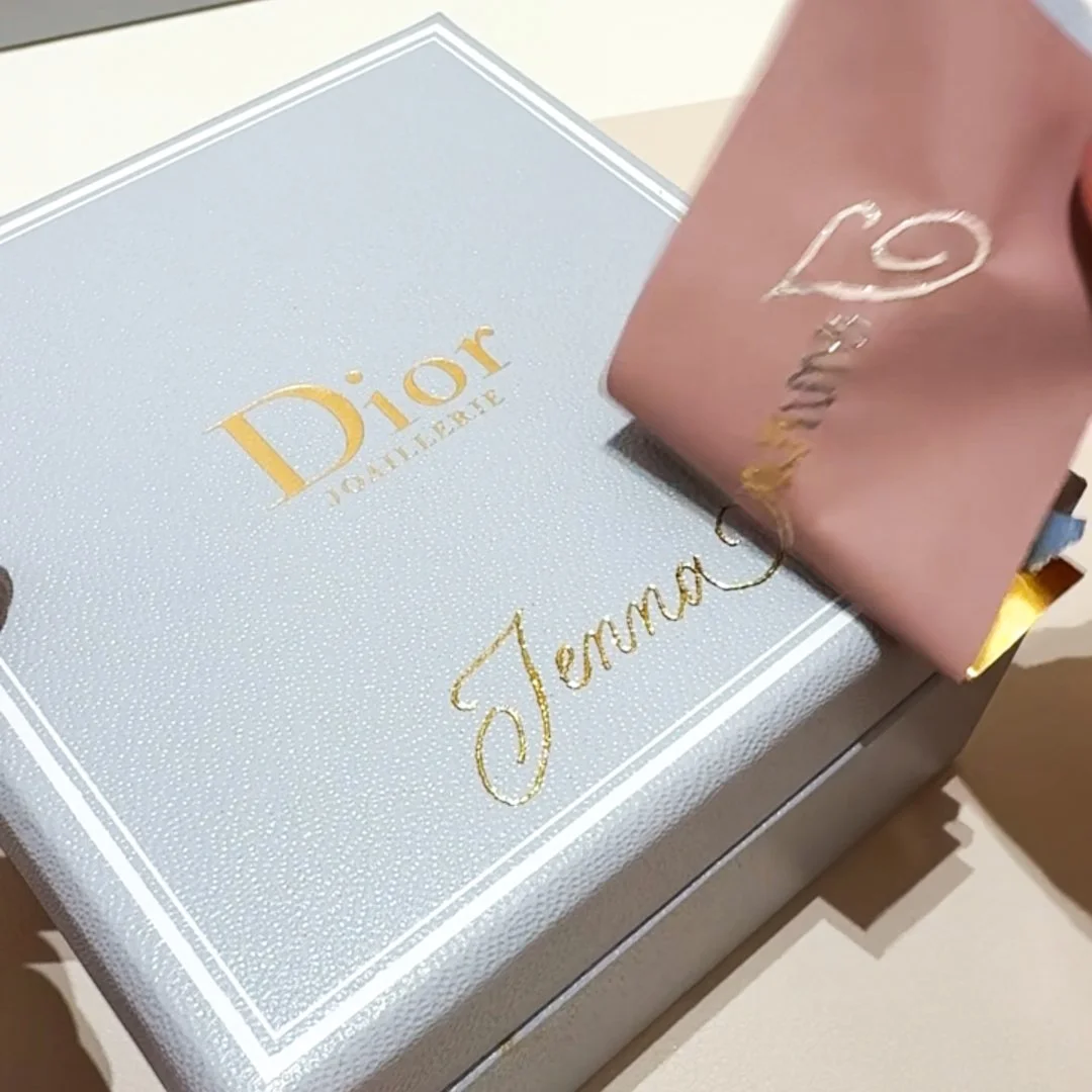 Hot foiling in gold on a Dior leather accessory for luxury event personalization