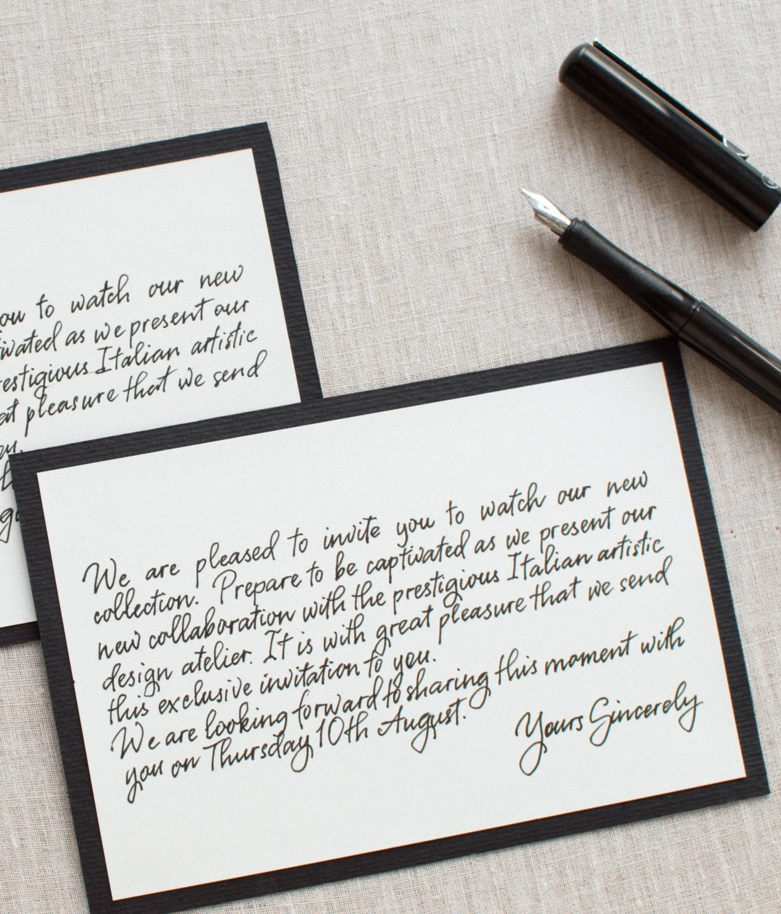 Handwritten event invitation with calligraphy and a dip pen