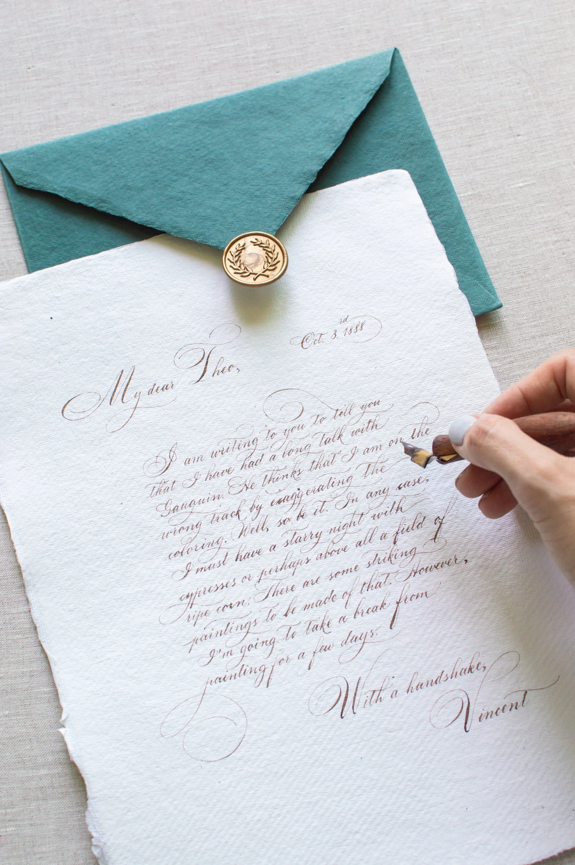 Workshop participant practicing modern calligraphy on a greeting card