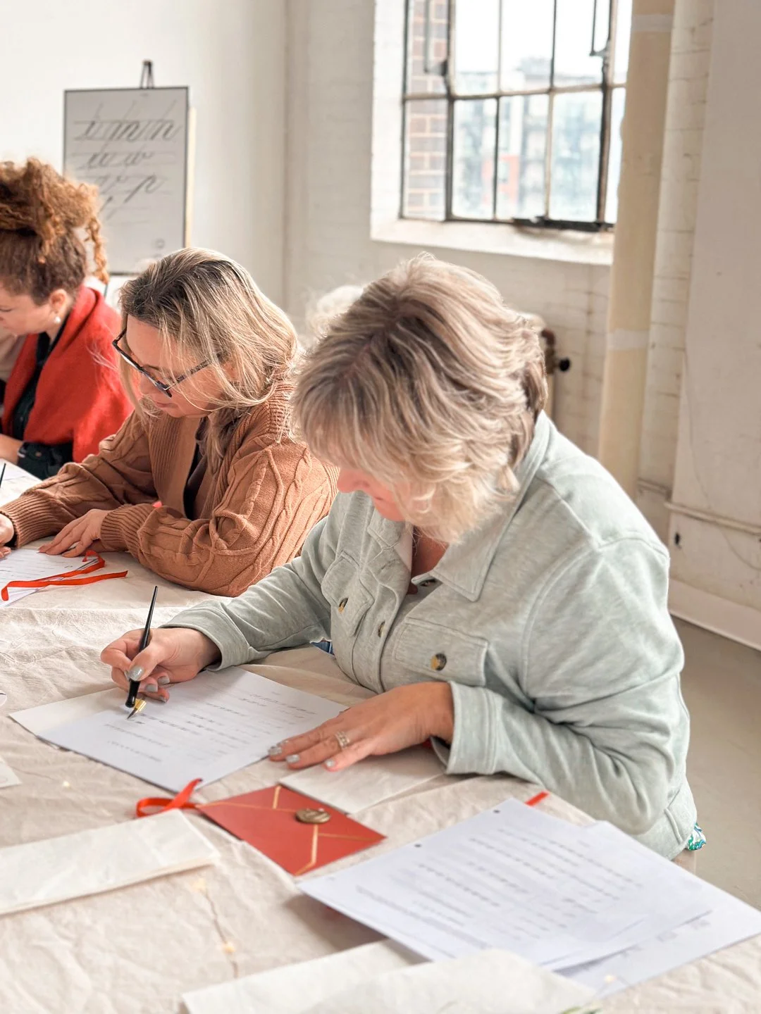 Participants practicing modern calligraphy during a corporate team-building workshop in Toronto