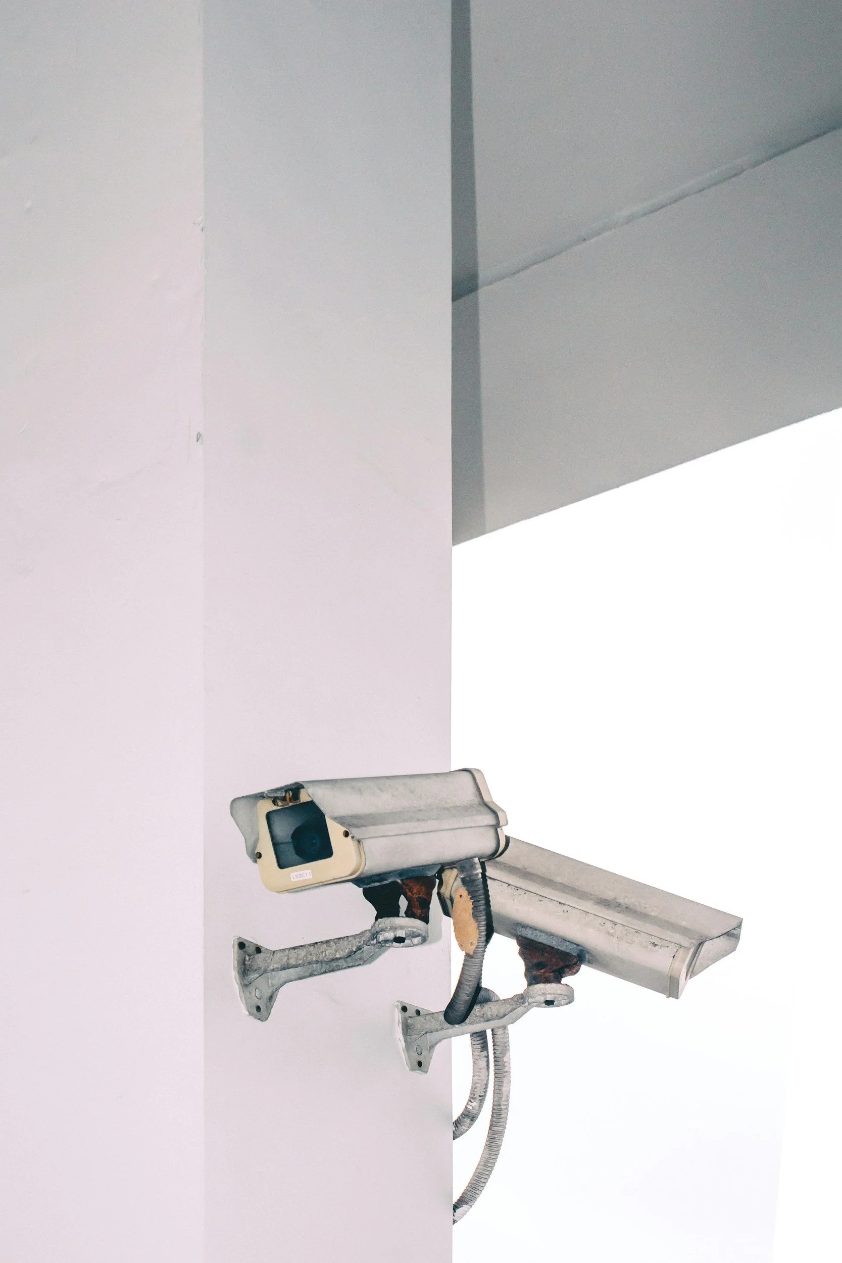 Security camera mounted on a wall near a ceiling