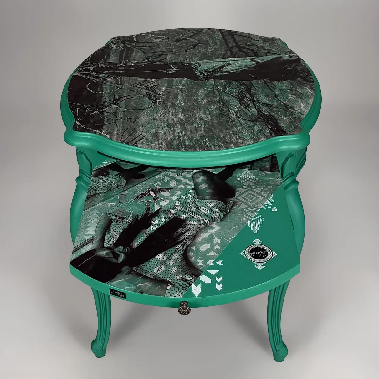 Decorative side table with a teal frame and green decoupage print of Mateo Beach, Lost Coast, Yarn Art- design including AMS and nature motifs.