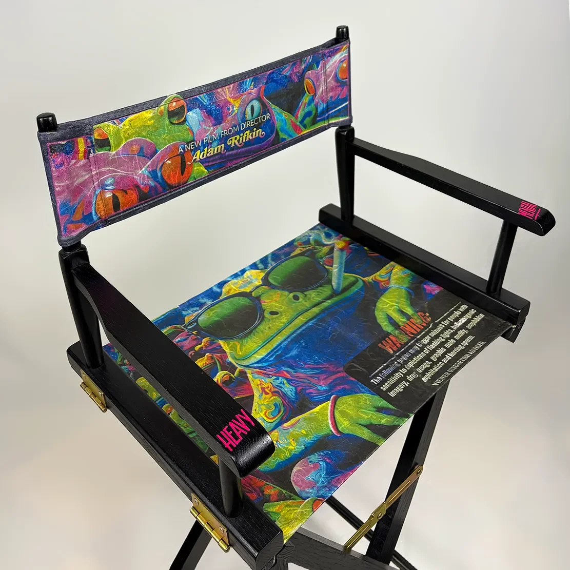 Colorful director's chair with psychedelic artwork (print of "TOAD" movie poster) and text promoting a film by Adam Rifkin, featuring a cartoonish green toad with sunglasses and a joint.
