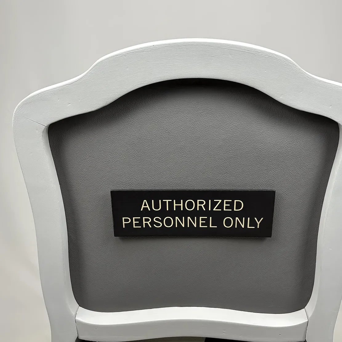 Chair with a sign that says 'Authorized Personnel Only'