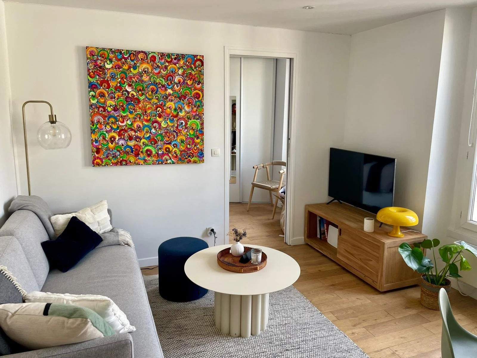 Christine Drummond colourful contemporary painting displayed in elegant modern Paris living room interior