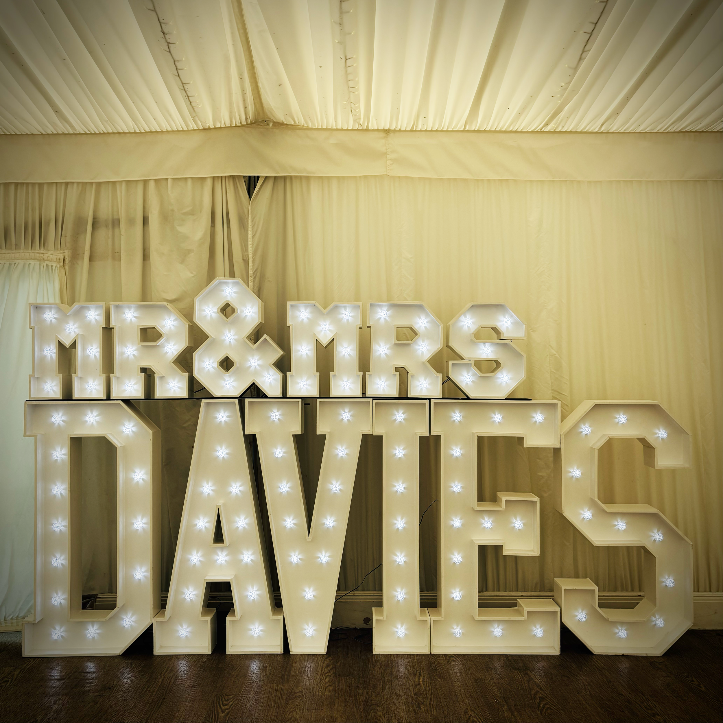 "Mr & Mrs Davies" light up letters at Quendon Hall in Essex.