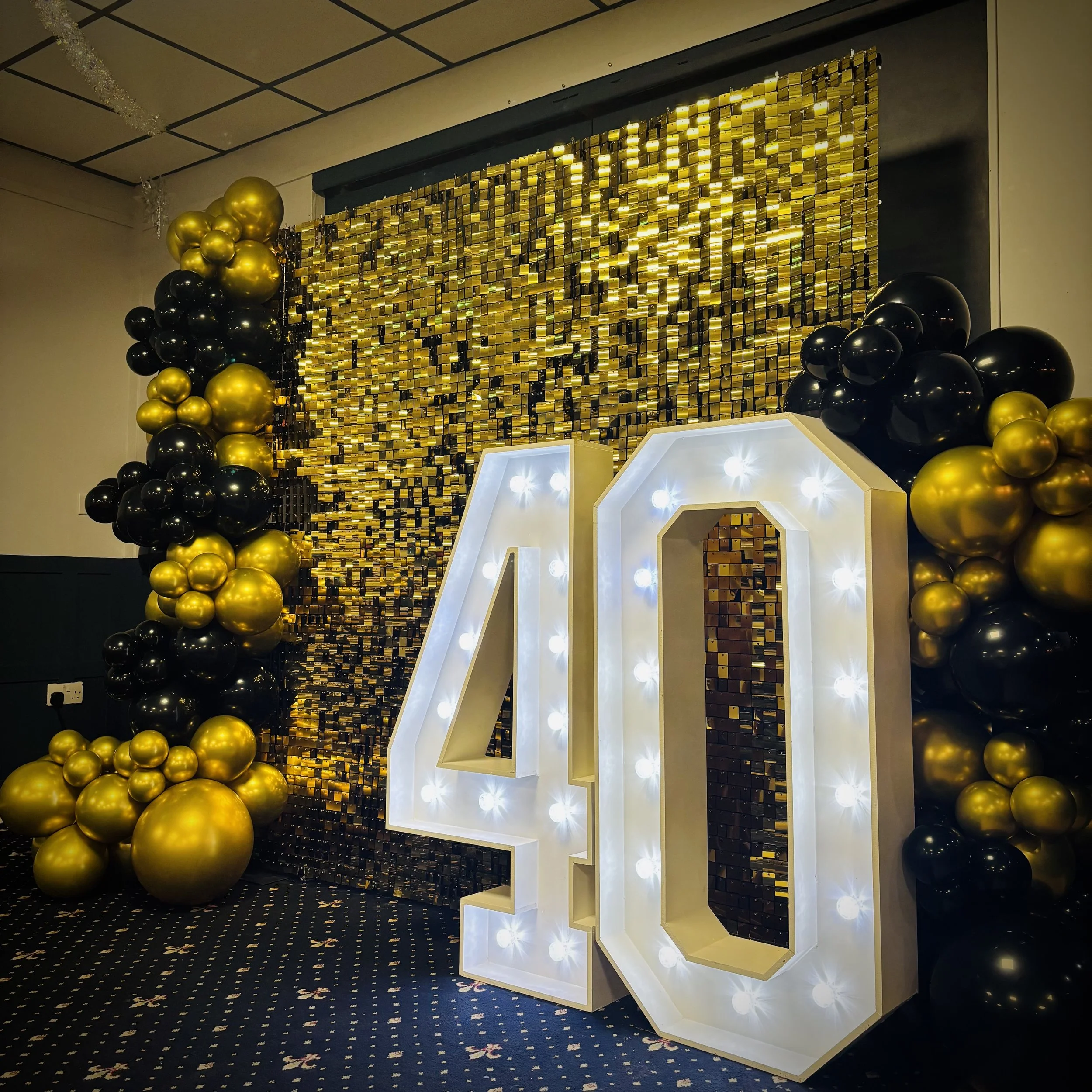 Gold Shimmer Wall with Balloon Decor and 4ft Light Up "40" for a birthday party in Burwell, Cambridge