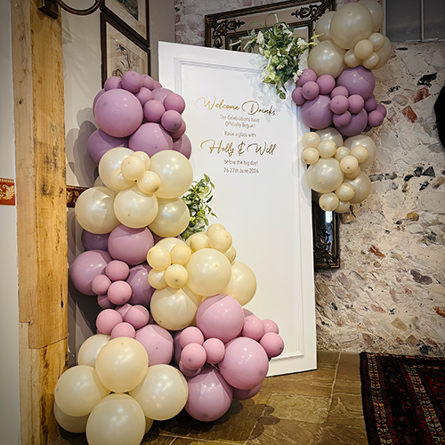 Personalised background with lilac and pearl balloons at The Packhorse Inn in Molton