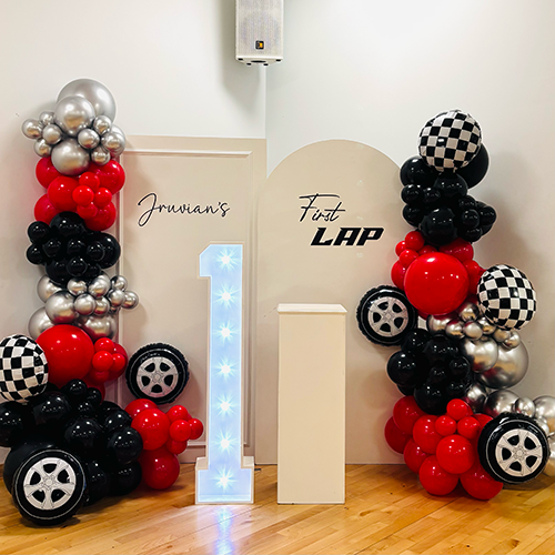 1st Birthday balloon display with personalised background and light up number 1 at The Hive Leisure Centre in Ely, Cambridgeshire