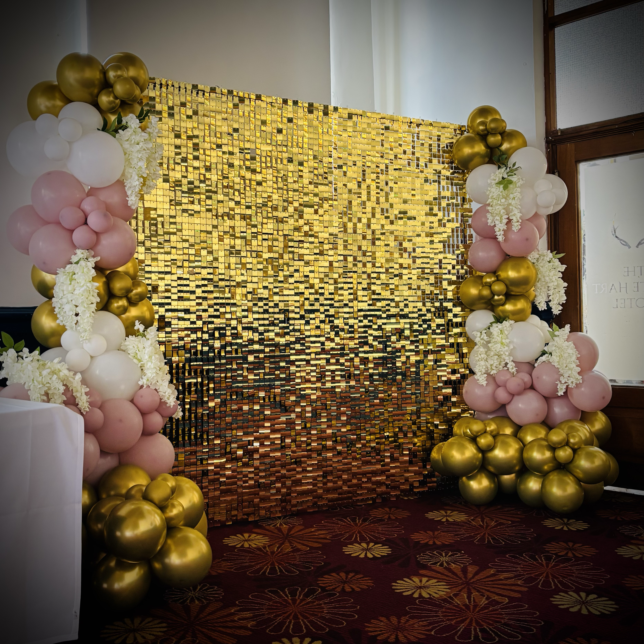 Gold shimmer wall with balloon decor supplied for an engagement party at The White Heart in Newmarket
