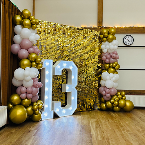 Gold shimmer was with gold, cream and pink balloons and light up 13 for a birthday party in Bury St Edmunds