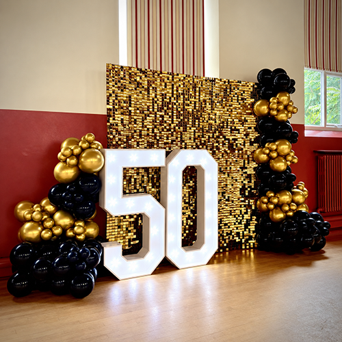 Gold Shimmer wall, balloon decor and light up 50 for a birthday party in Newmarket, Suffolk
