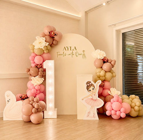 Personalised first birthday desplay with balloon decor. light up number 1, cake and and cut outs at Waterbeach Village Hall, Cambridge