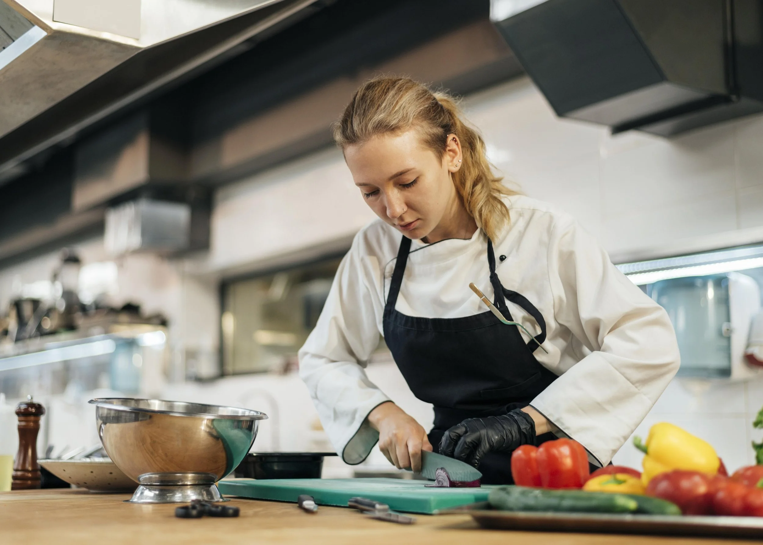 female-chef-chopping-vegetables-kitchen.jpg