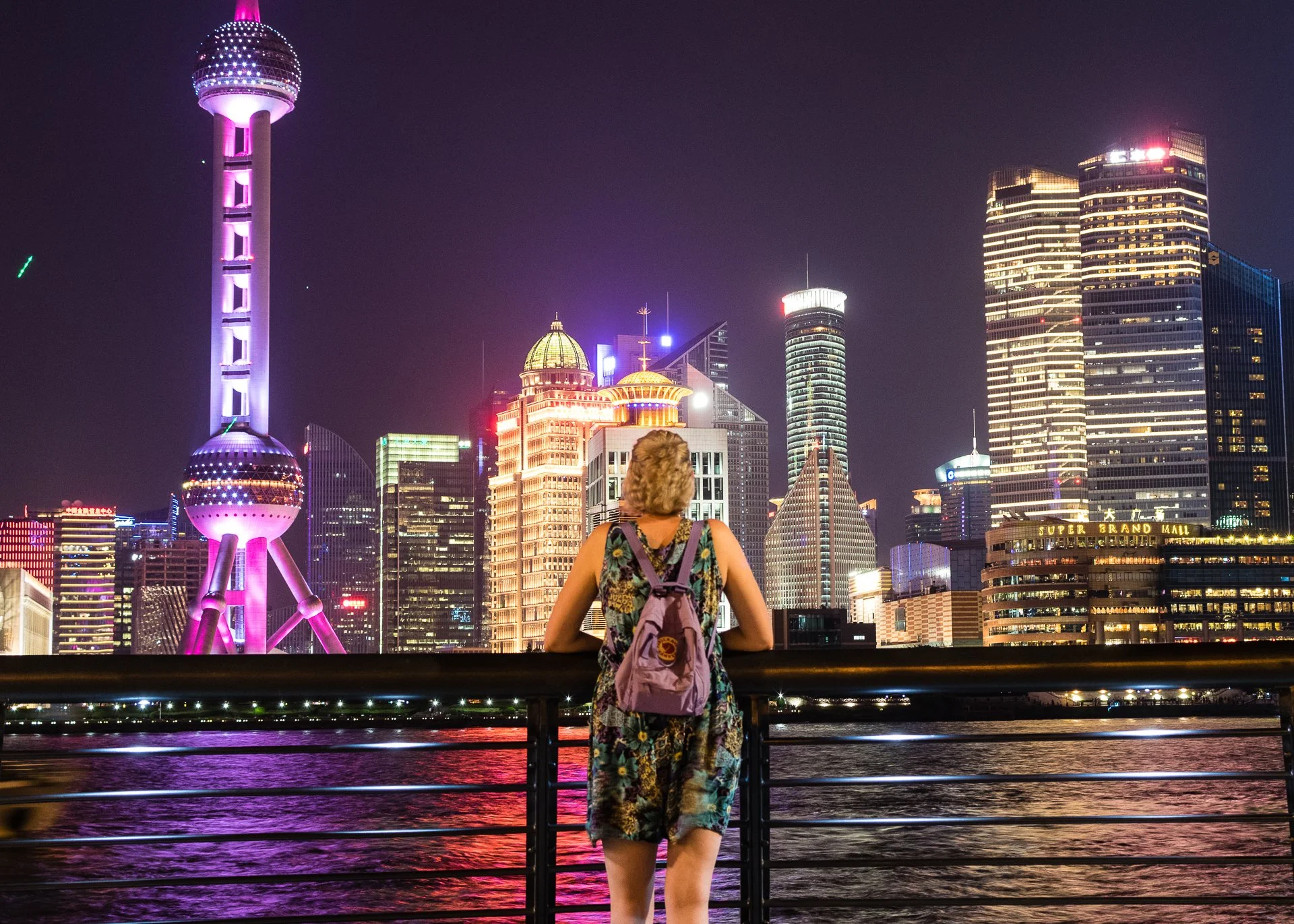 Women standing on the Bund with Shanghai's skyline behind her