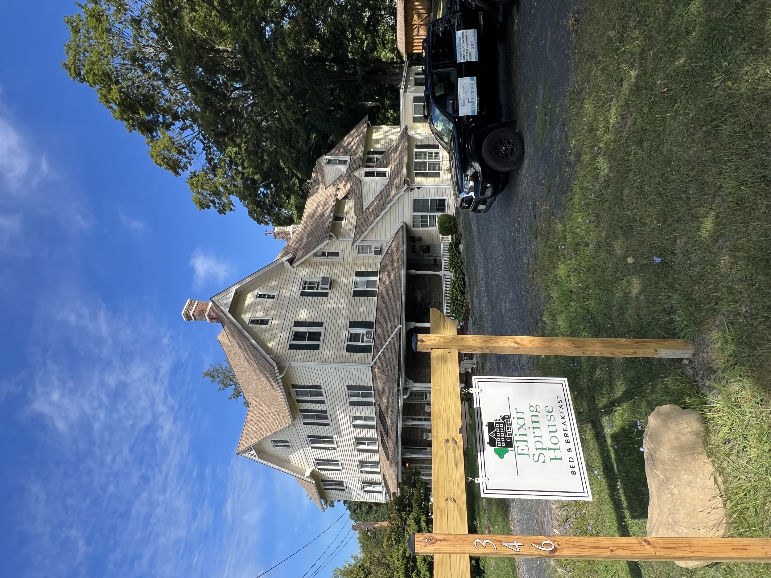 Commercial building being power washed removing moss stains and cleaning it to its original condition 