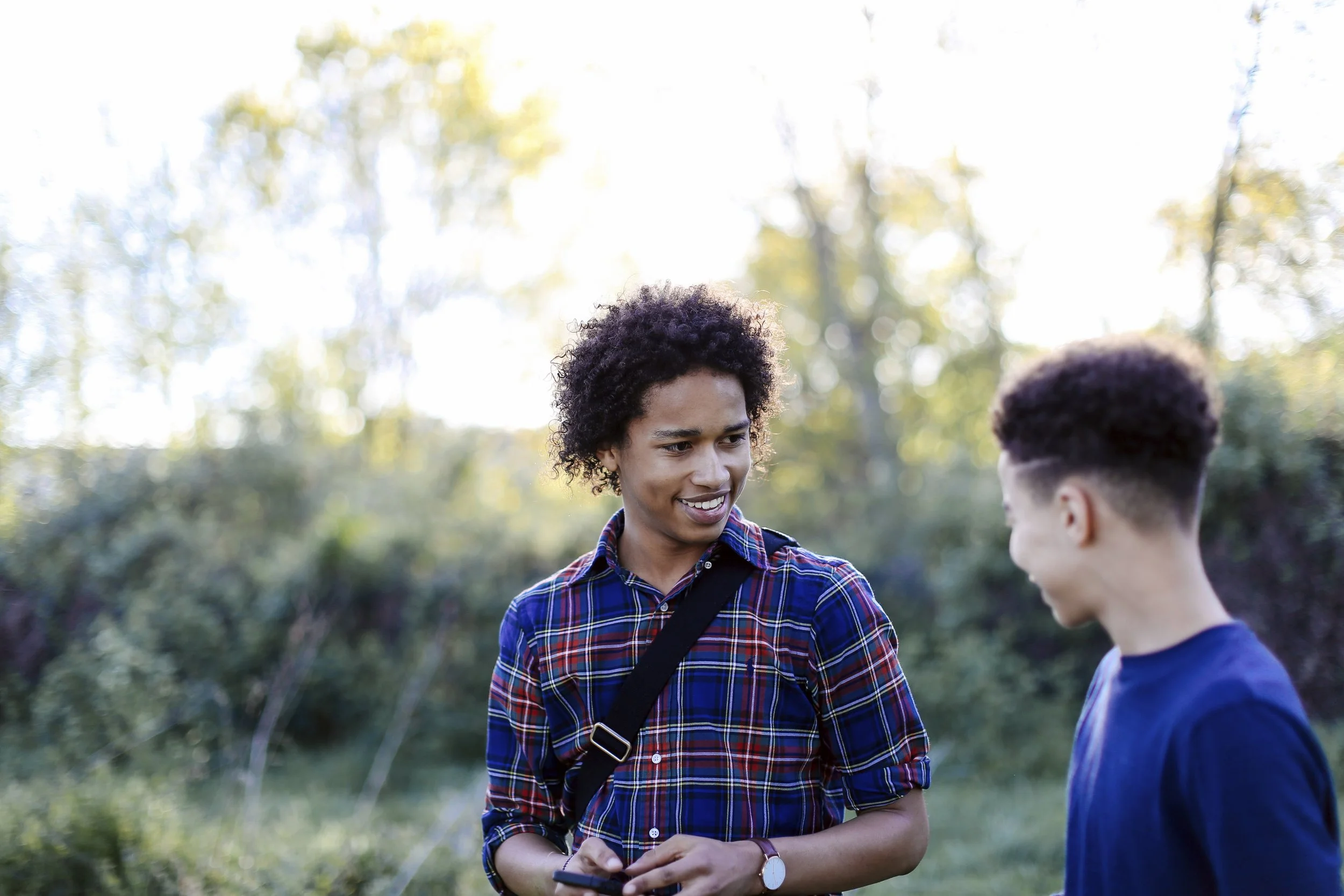 two-male-friends-walking-through-park-having-con-2025-04-04-12-43-55-utc.jpg