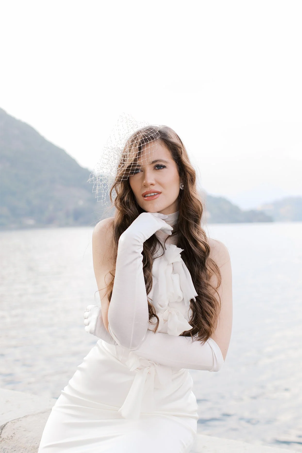 A modern portrait of a bride, wearing bridal dress, getting ready for the wedding at Villa Aura del Lago, Limonta, Italy.