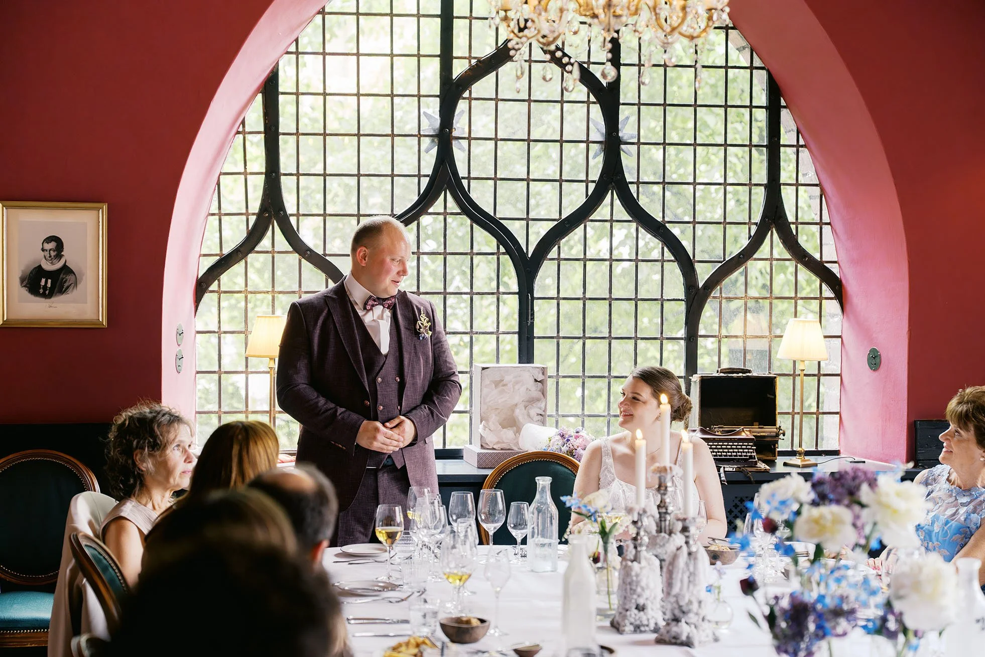 A groom giving a speech at a wedding reception and looking at his wife, the location is at Maven restaurant in Copenhagen, captured by Duo Chen.