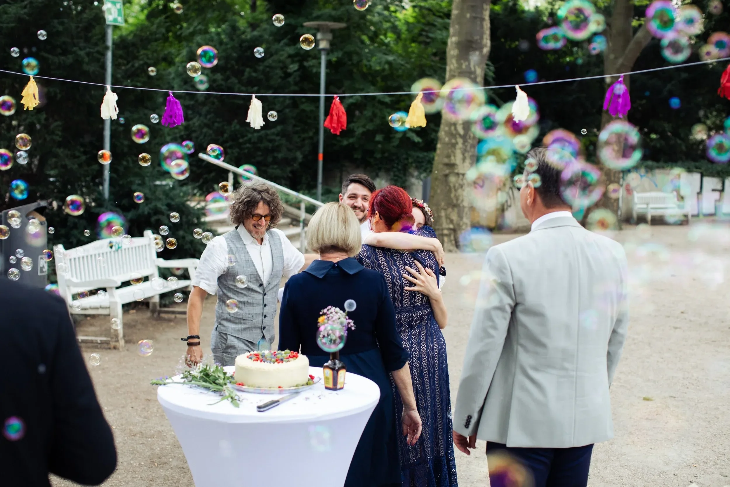 hugging at wedding at one of the beautiful parks in schöneberg​