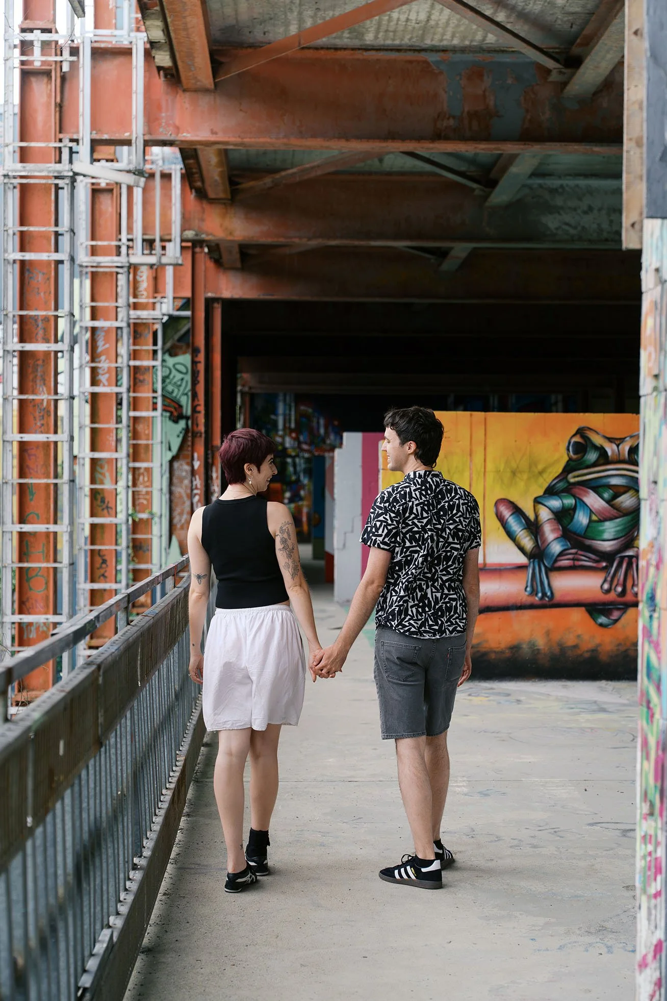Couple photography at graffiti wall at Teufelsberg, Berlin.