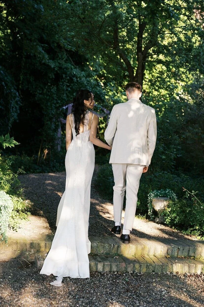 Couple walking up steps in the gardens of Gut Schloss Golm