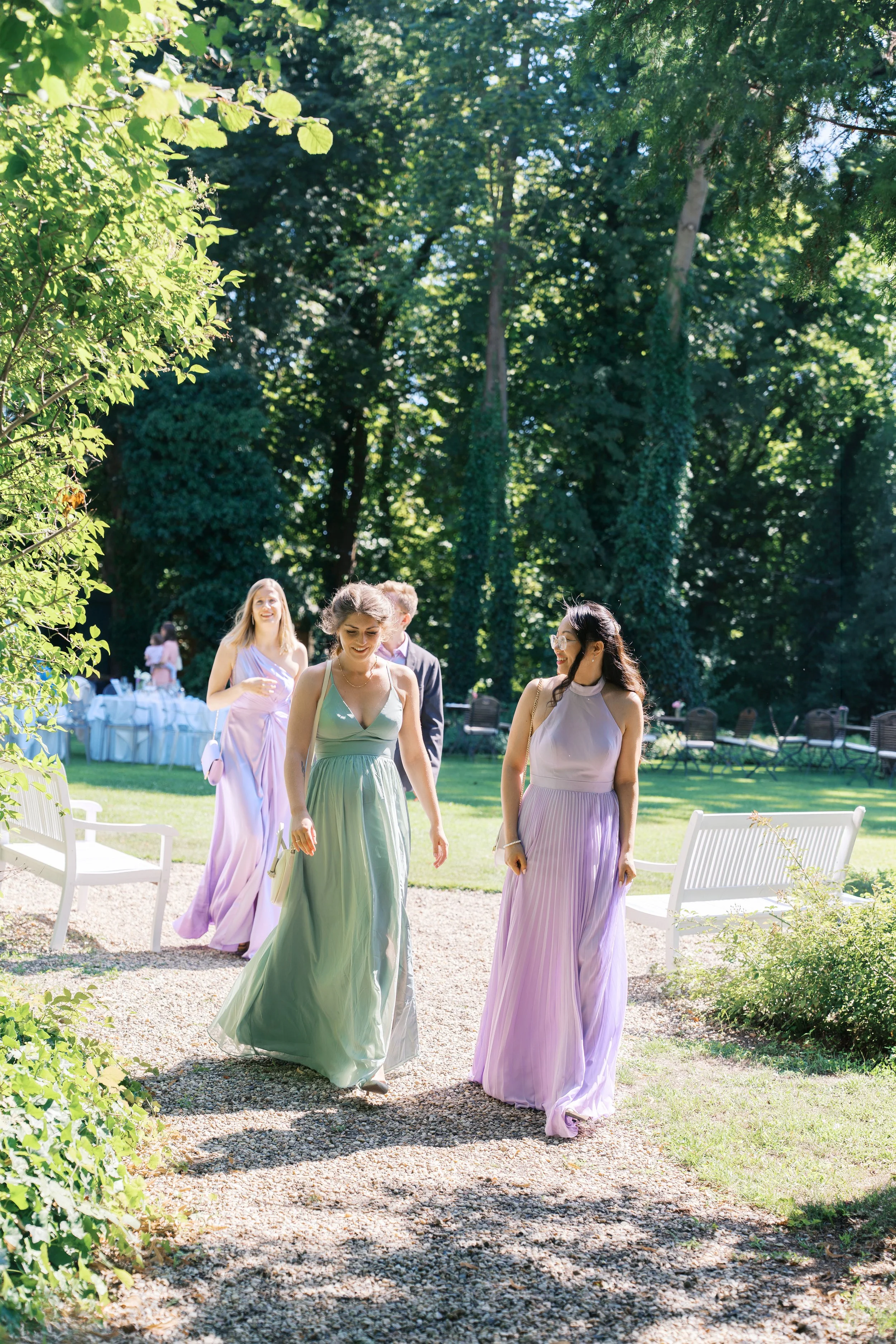 Guests with lavender and green dresses on walking to a Gut Schloss Golm wedding reception