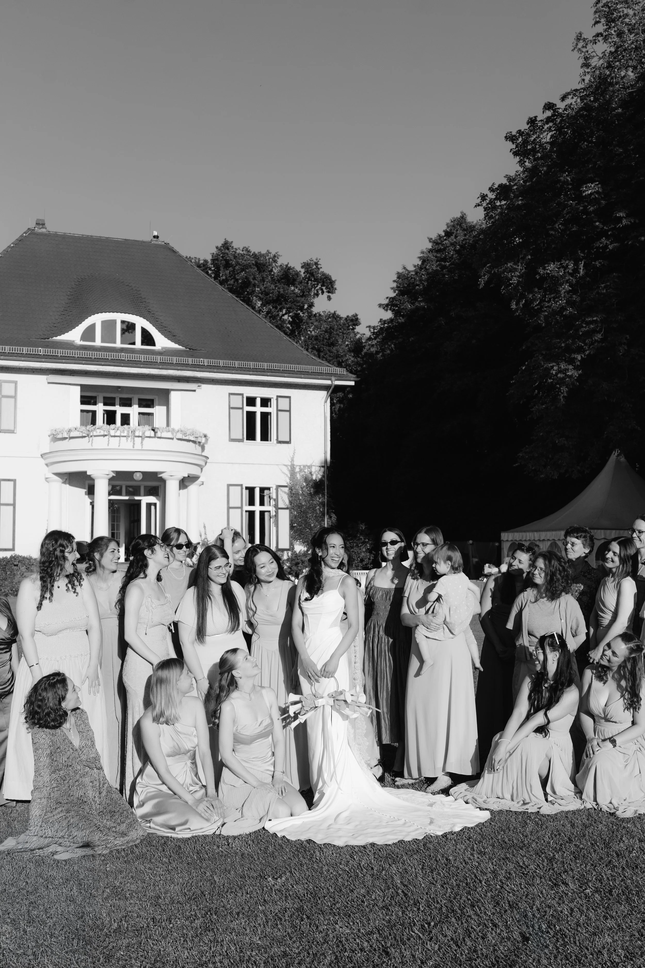 Bride and her guests posing outside of Gut Schloss Golm's estate.