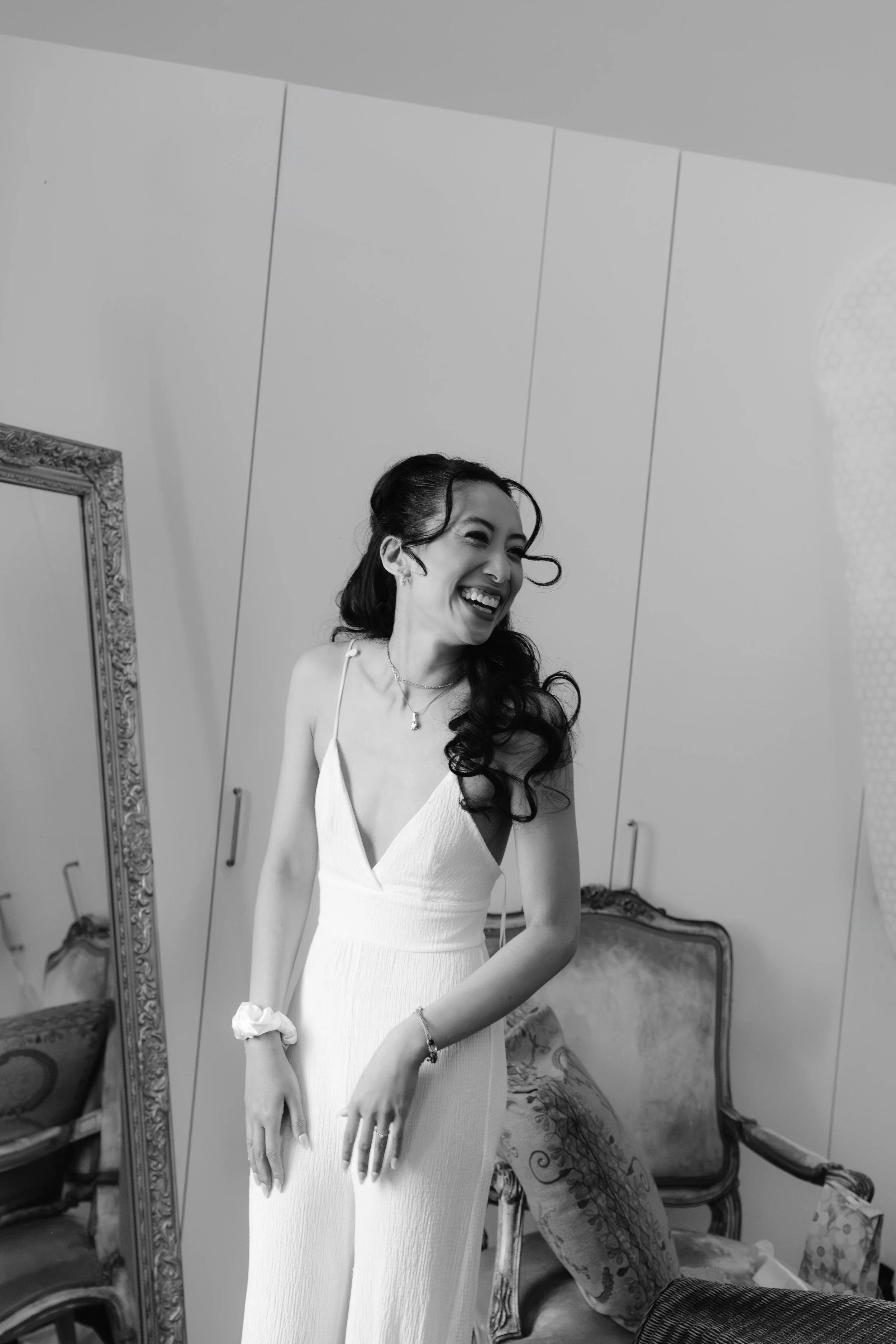 Black and white photo of bride smiling at someone at a Gut Schloss Golm wedding
