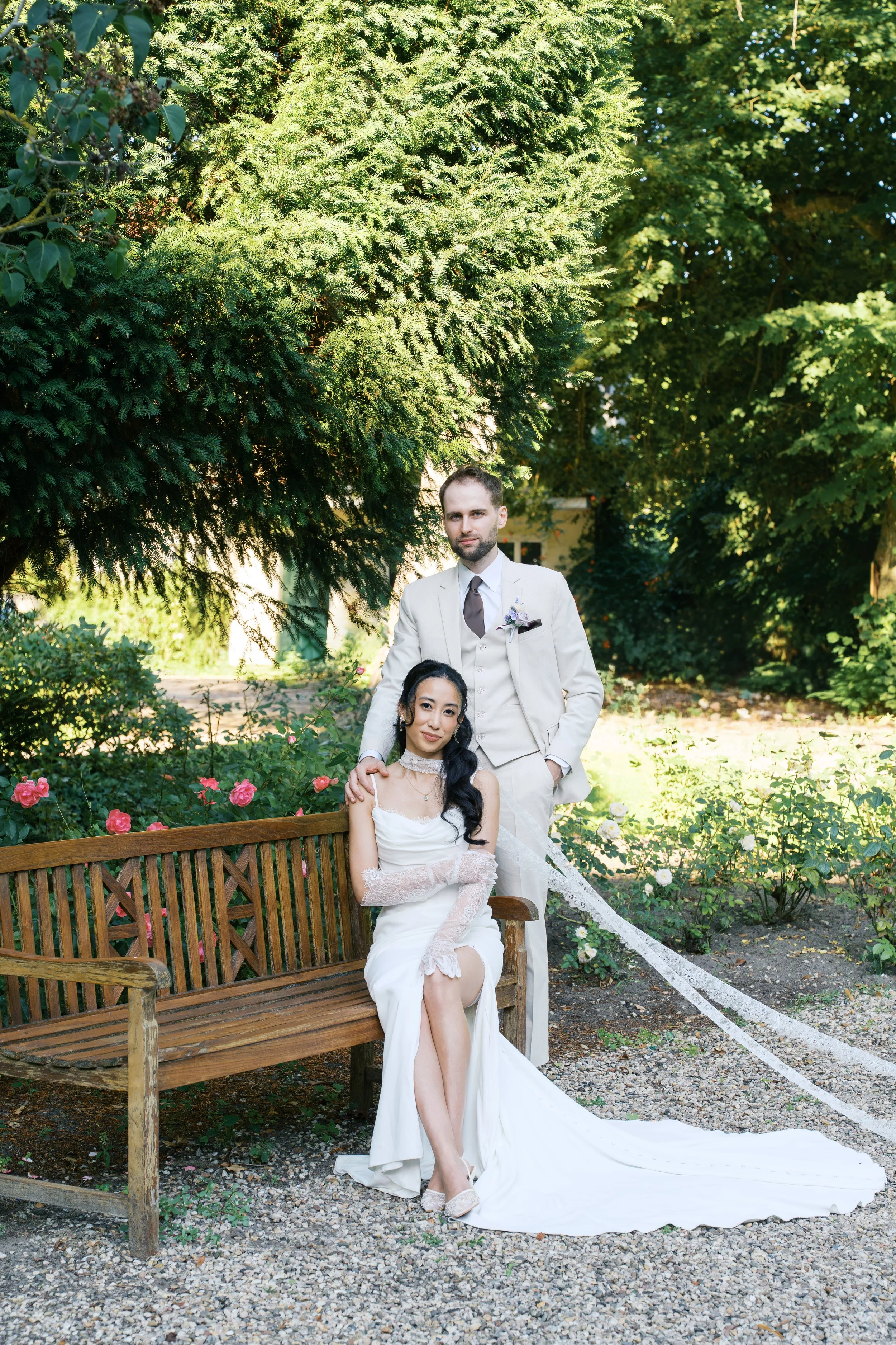 Bride and groom posing at Gut Schloss Golm gardens outside