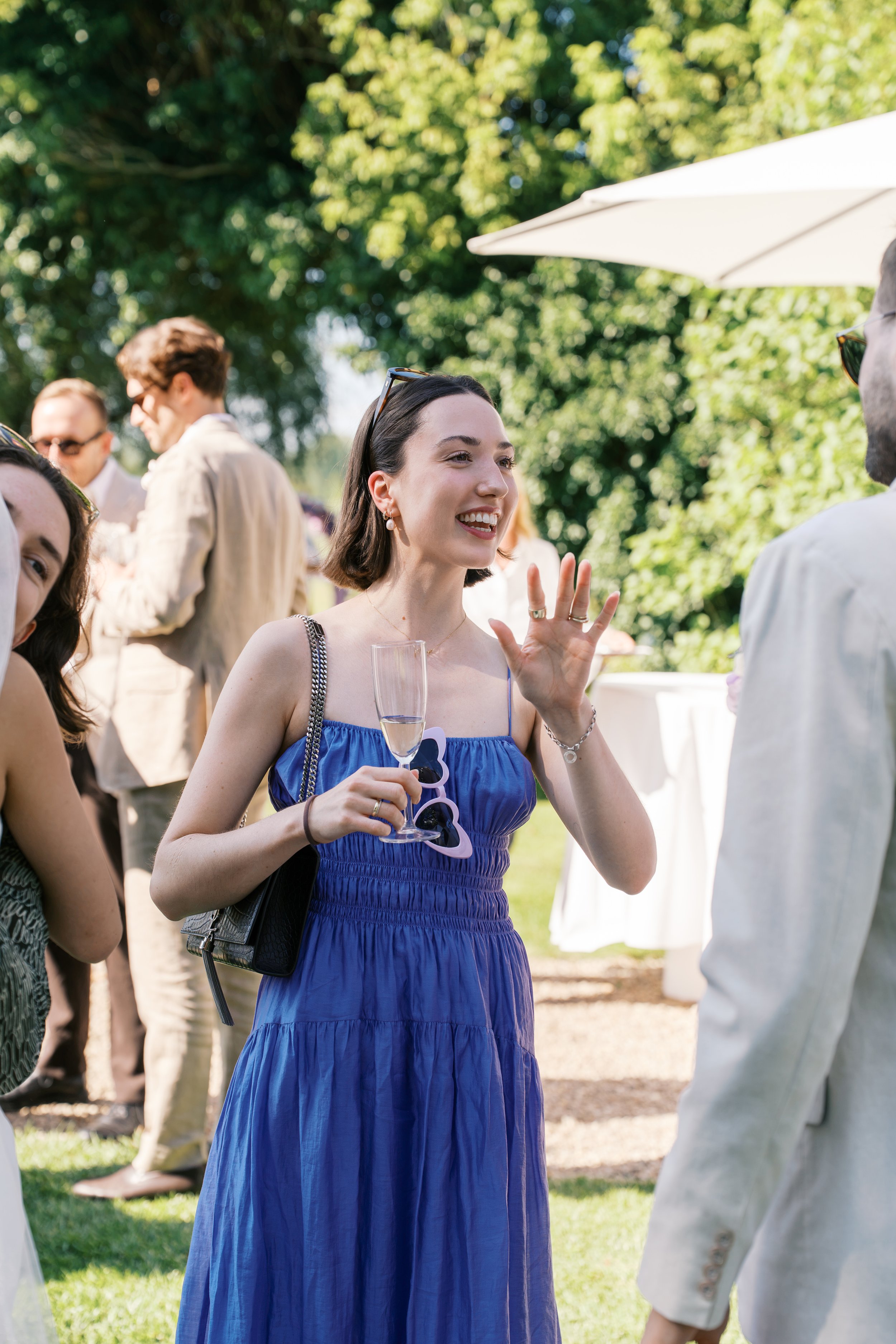 Woman in blue dress mingling with other guests at a Gut Schloss Golm wedding