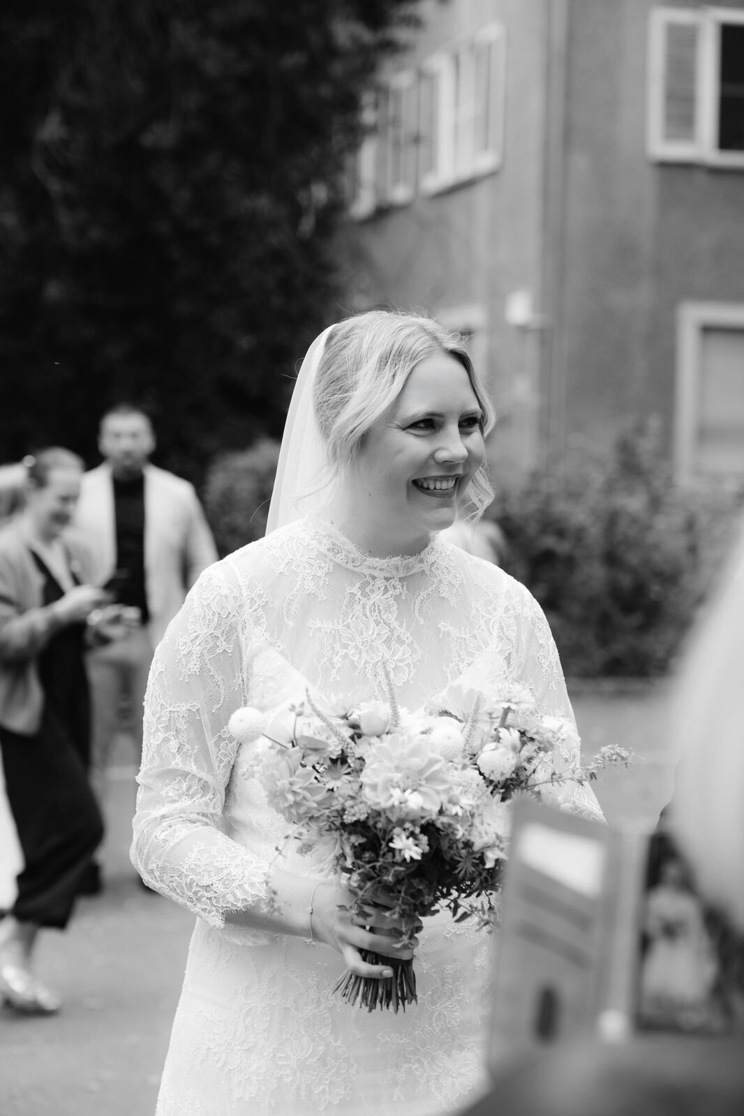 Bride talking with guests after ceremony outside of Hochzeitsvilla in Berlin