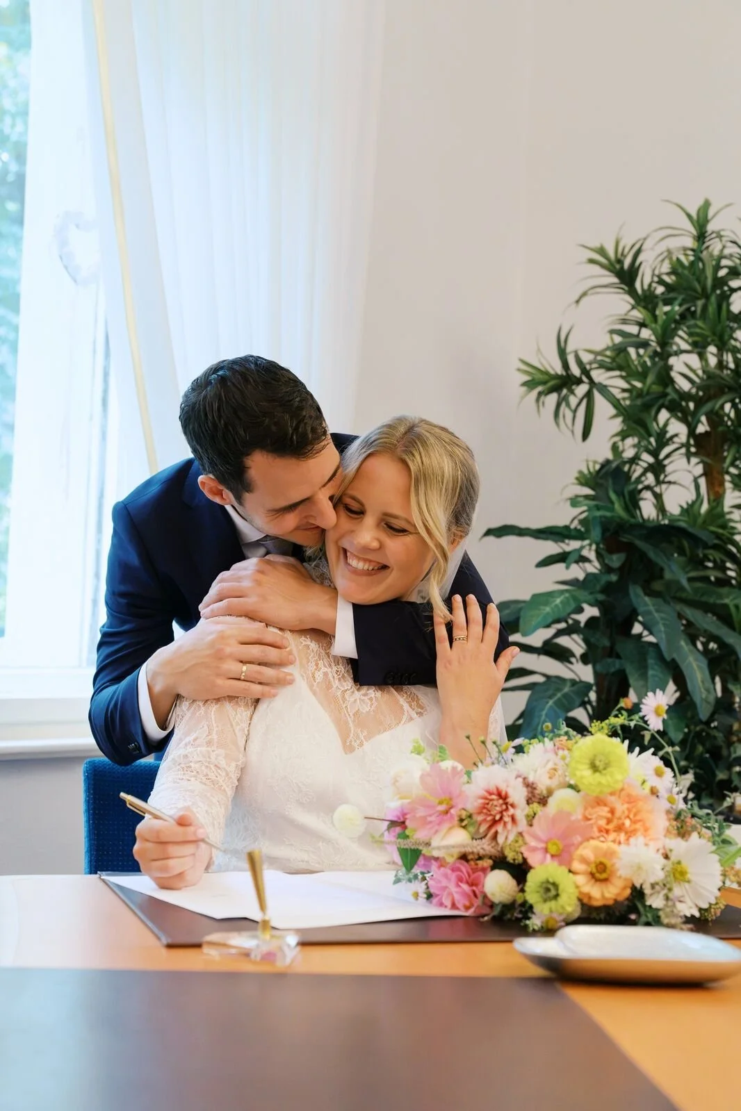 Bride and groom signing documents for their wedding at Hochzeitsvilla in Berlin