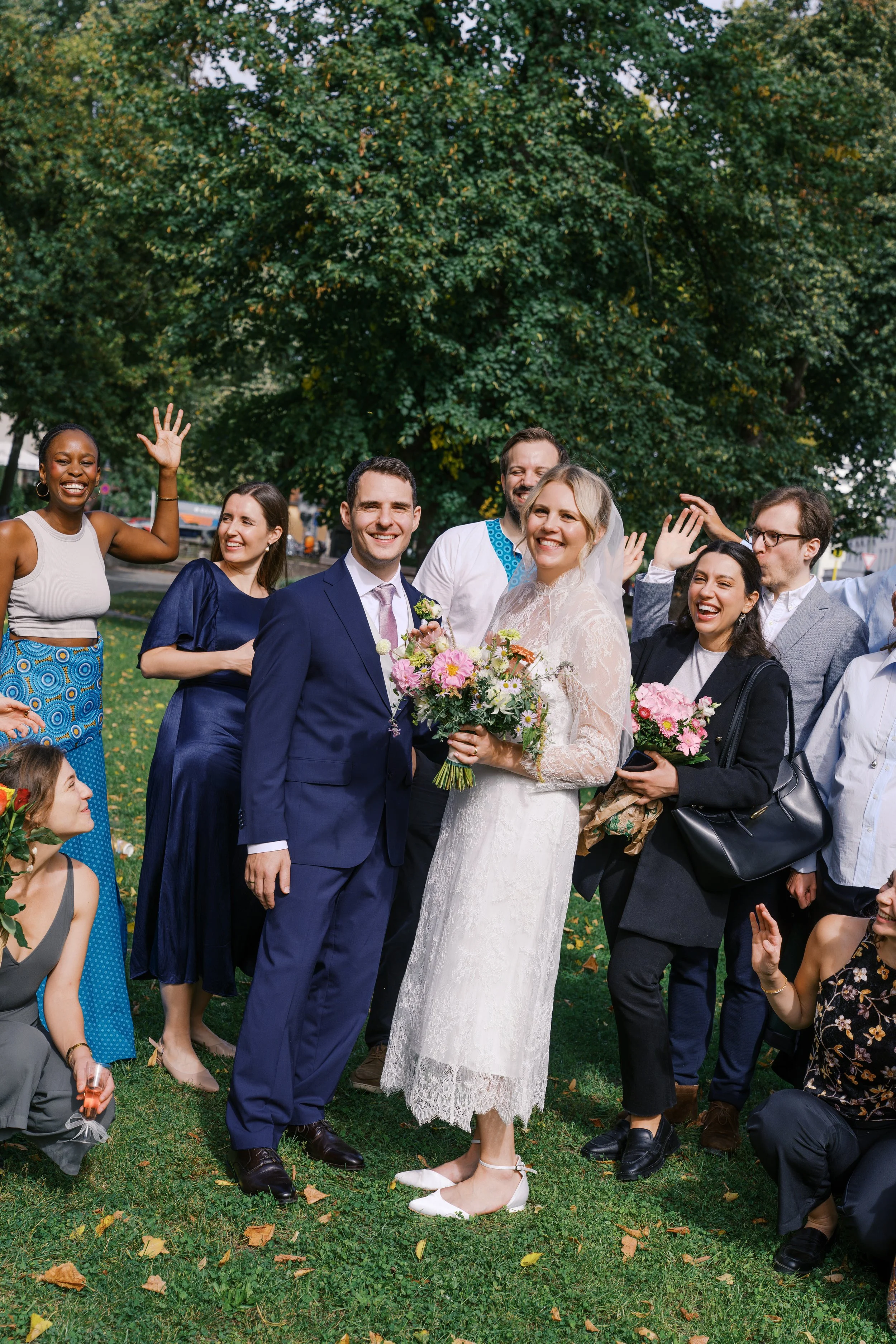 Bride and groom and guests stand out on lawn outside of the Hochzeitsvilla in Berlin