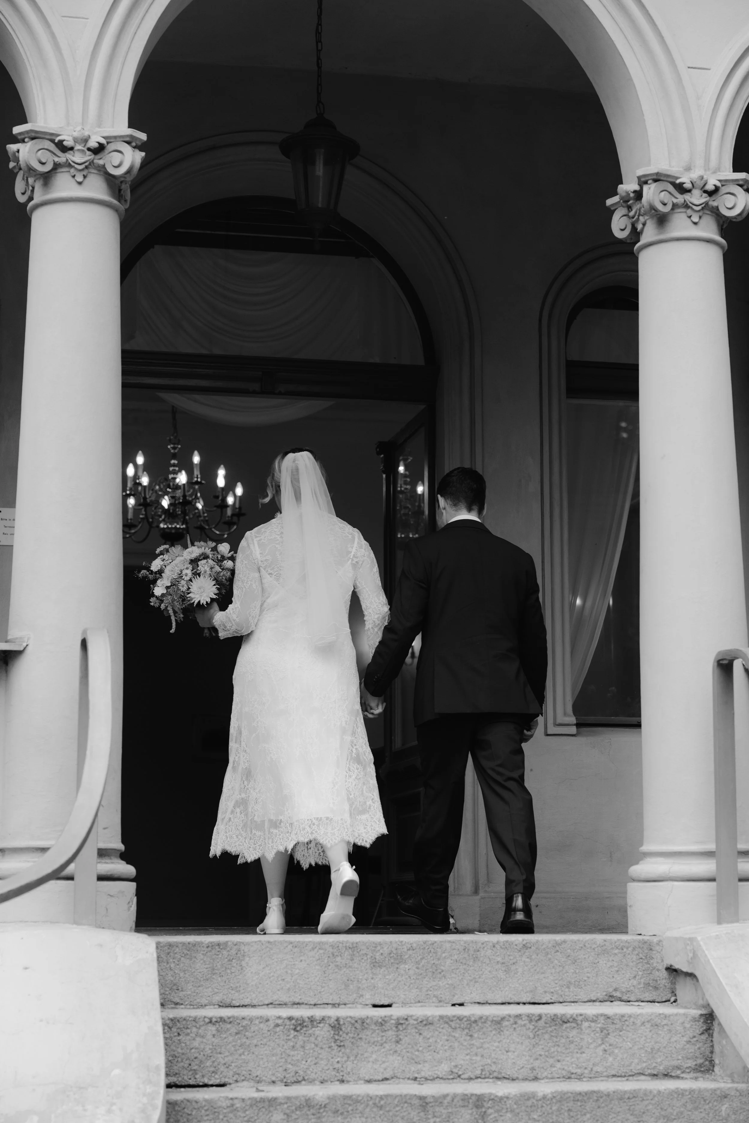Bride and groom walking into Hochzeitsvilla for their wedding