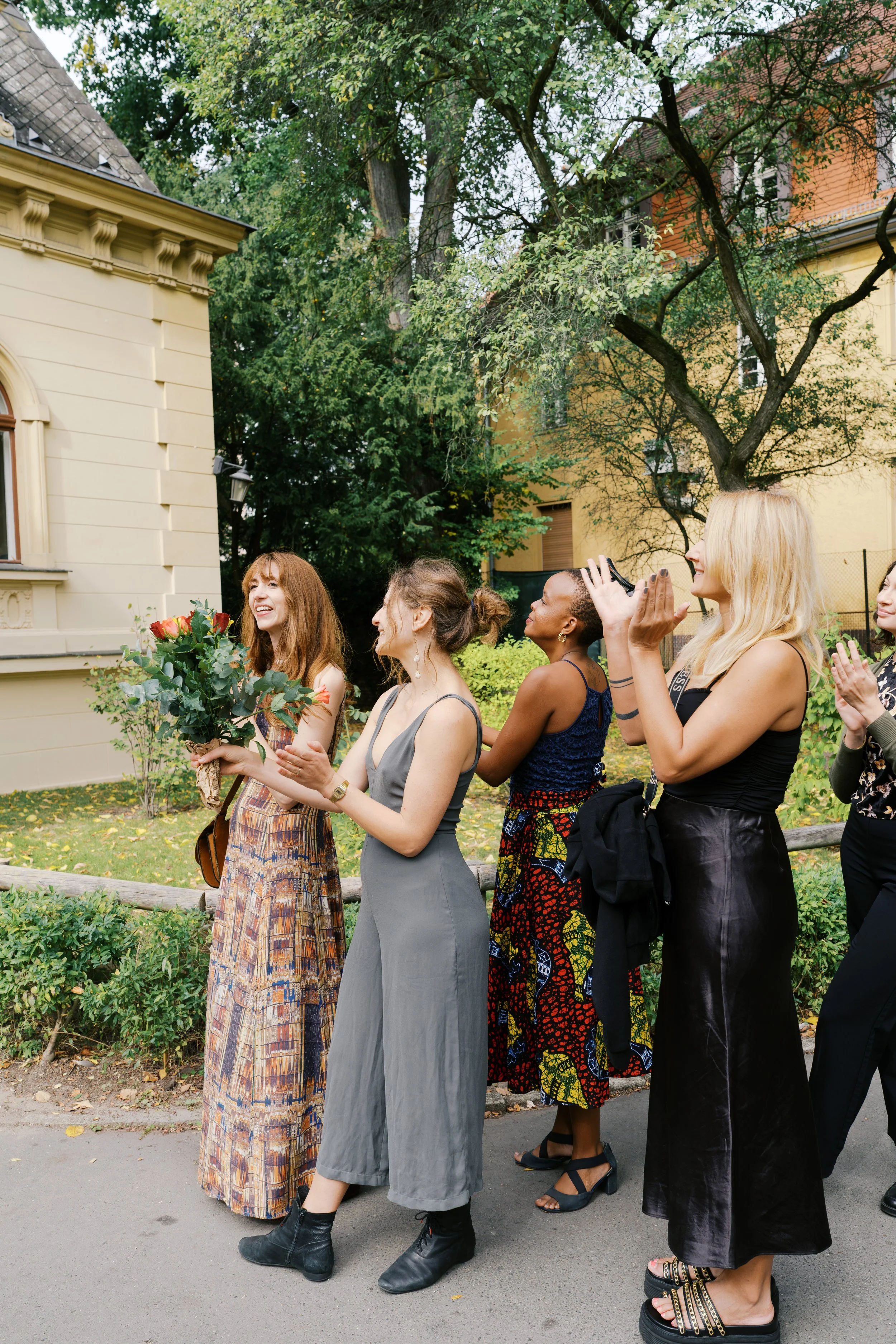 Guests clapping as bride and groom exit Hochzeitsvilla after their ceremony