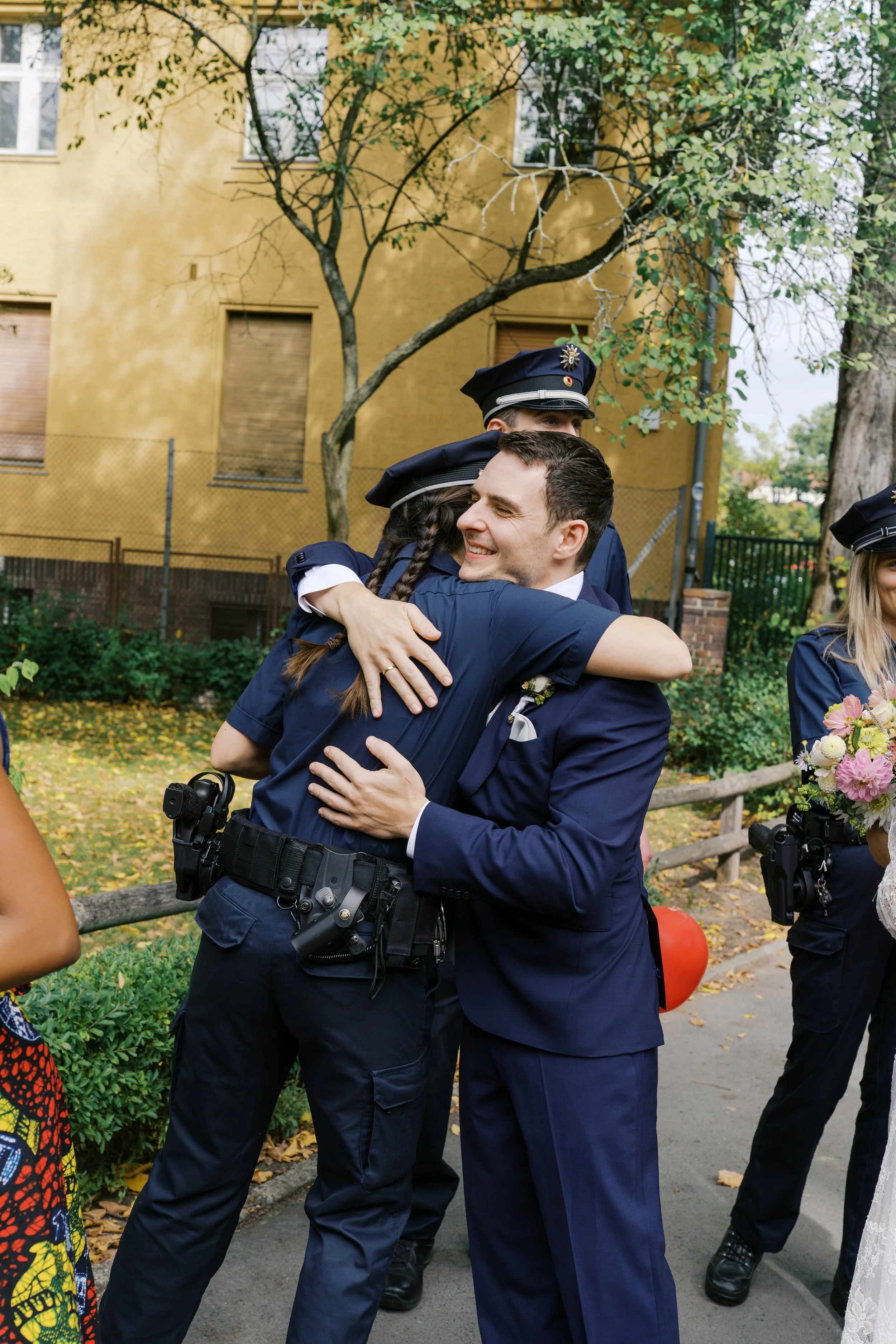 Groom hugging friends after his wedding at Hochzeitsvilla